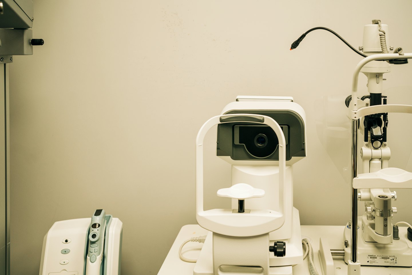 Optometry office equipped with an auto-refractor and slit lamp.